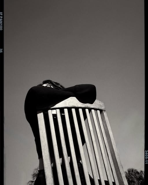 Editorial black and white portrait framed by a chair