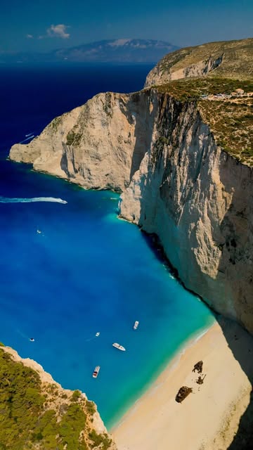 Aerial view of a blue cove and dramatic coastline in Greece